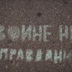a street sign that is written in white chalk