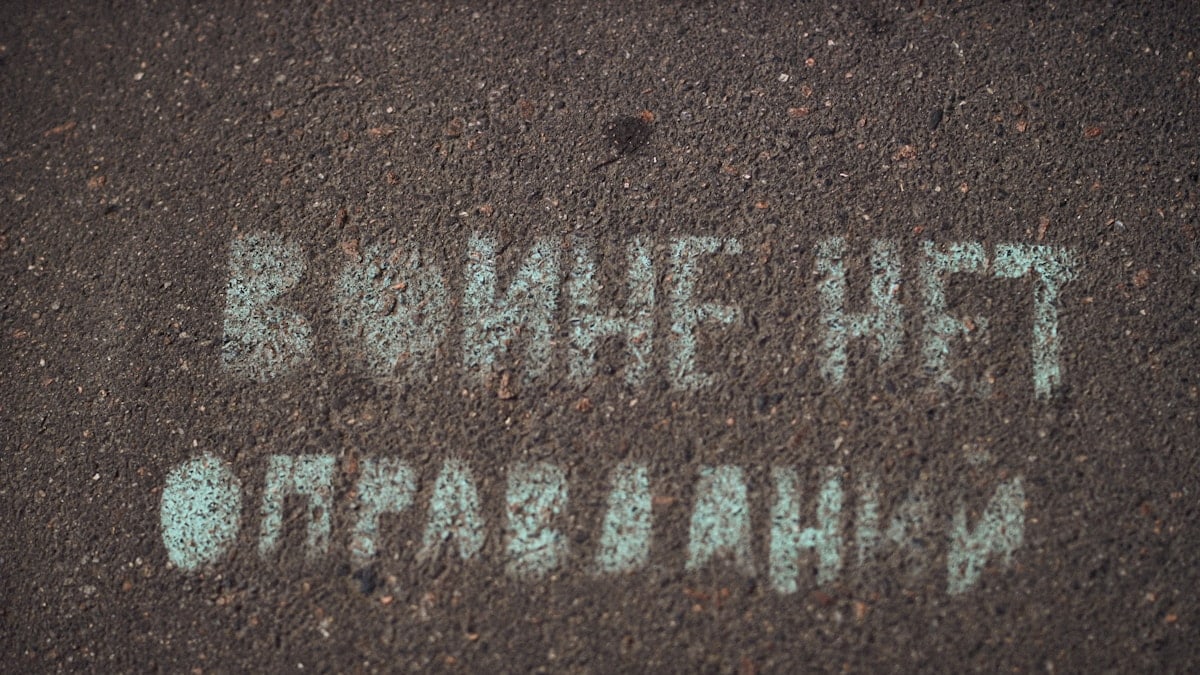 a street sign that is written in white chalk